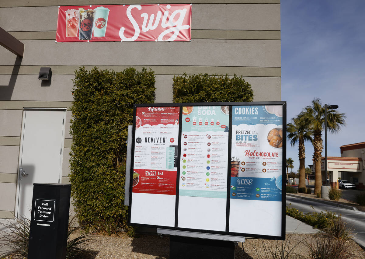 Menus are posted at the drive-thru of Swig, a Utah-based soda chain, is seen in Las Vegas in th ...