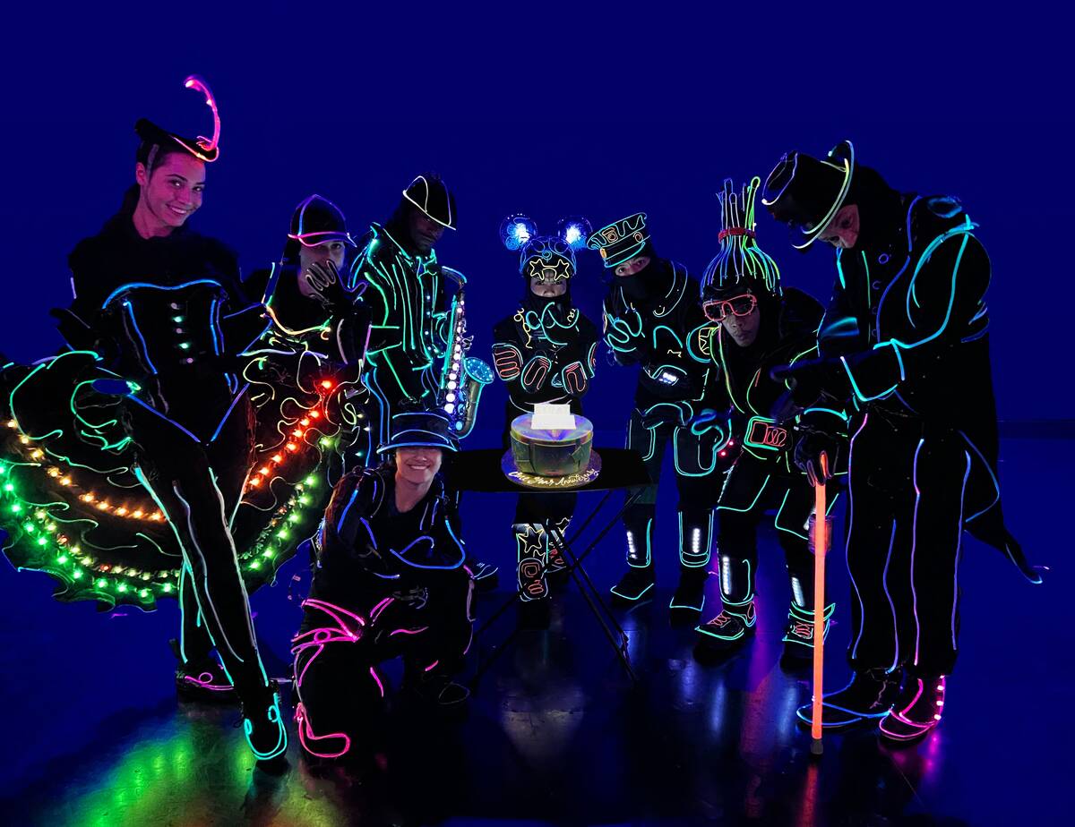 The cast of “illuminate” at The Strat celebrates its one-year anniversary, with cak ...