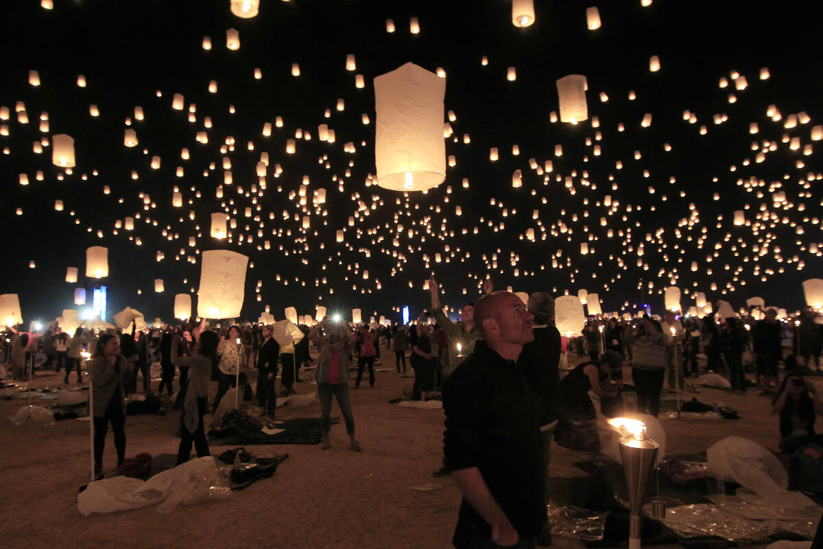 Paper lanterns are released and float to the sky at the RiSE Festival Saturday, Oct. 18, 2014, ...
