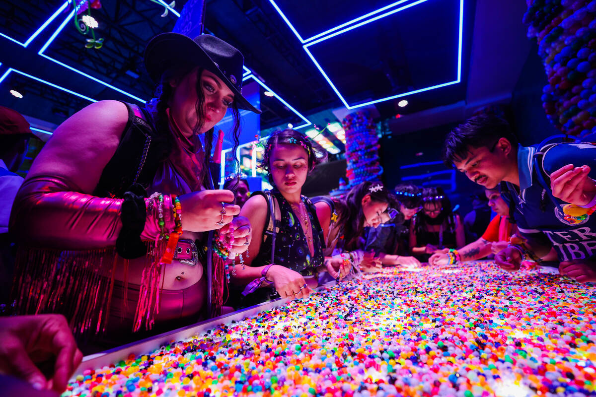 Festival attendees make kandi bracelets during day one of the Electric Daisy Carnival festival ...