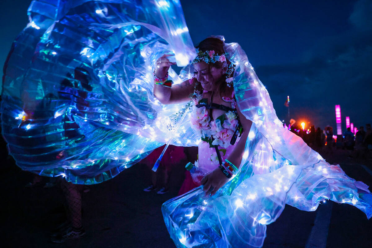 Isabel Serrano plays with her light up cape during day one of the Electric Daisy Carnival festi ...