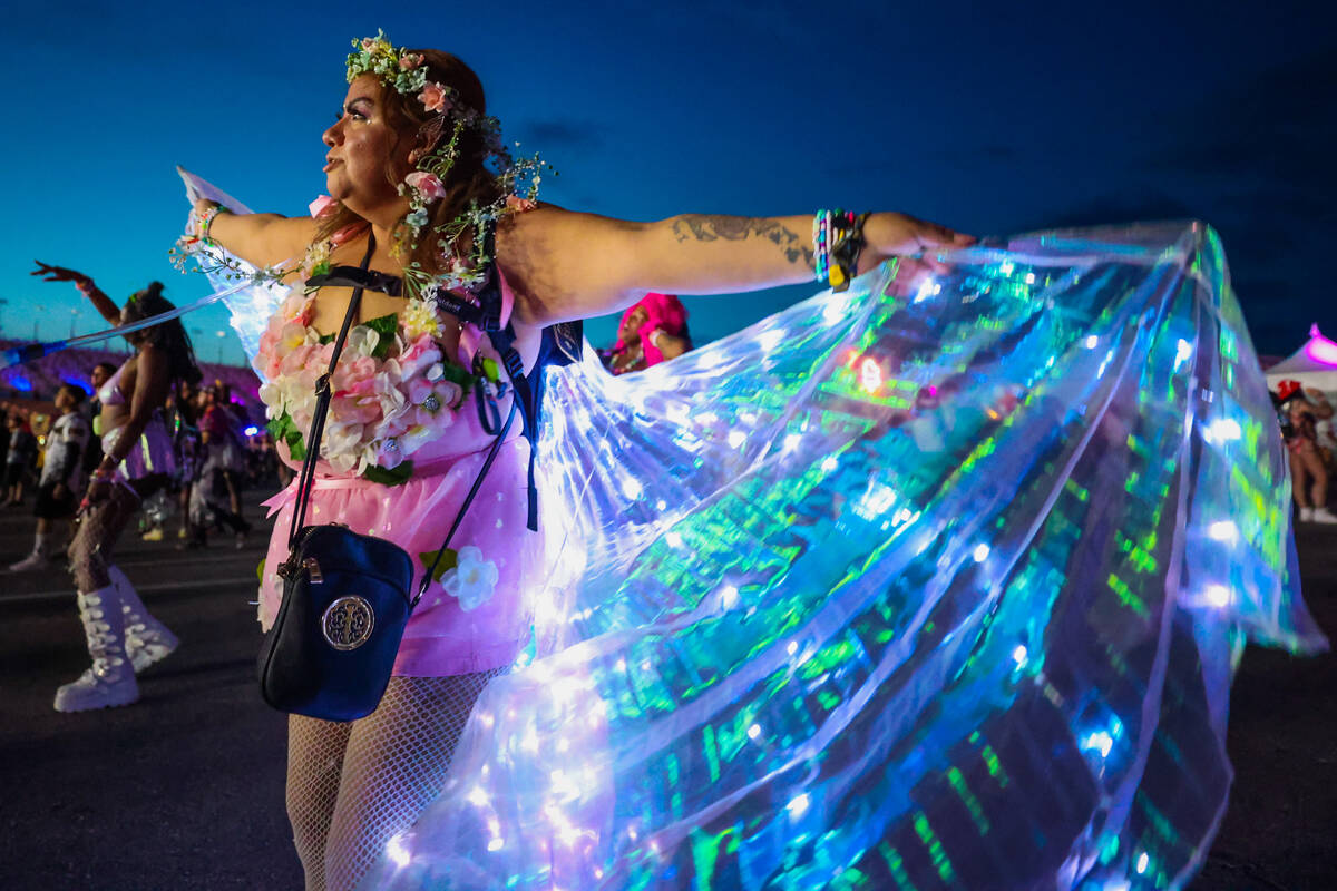 Isabel Serrano plays with her light up cape during day one of the Electric Daisy Carnival festi ...