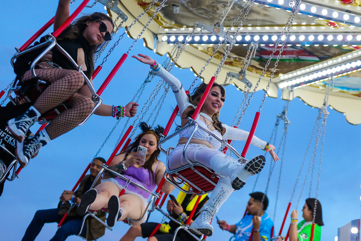 Festival attendees take in a ride during day one of the Electric Daisy Carnival festival at the ...