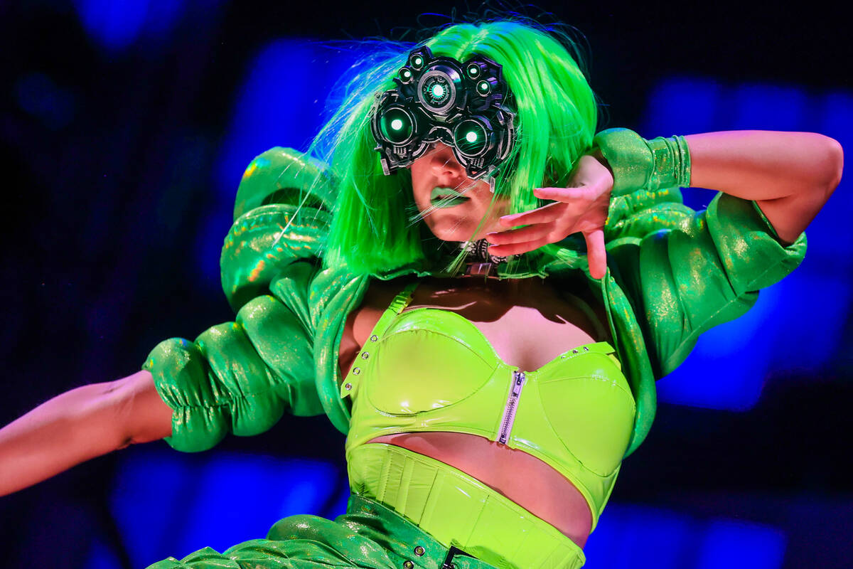 Performers dance to a DJ set during day one of the Electric Daisy Carnival festival at the Las ...