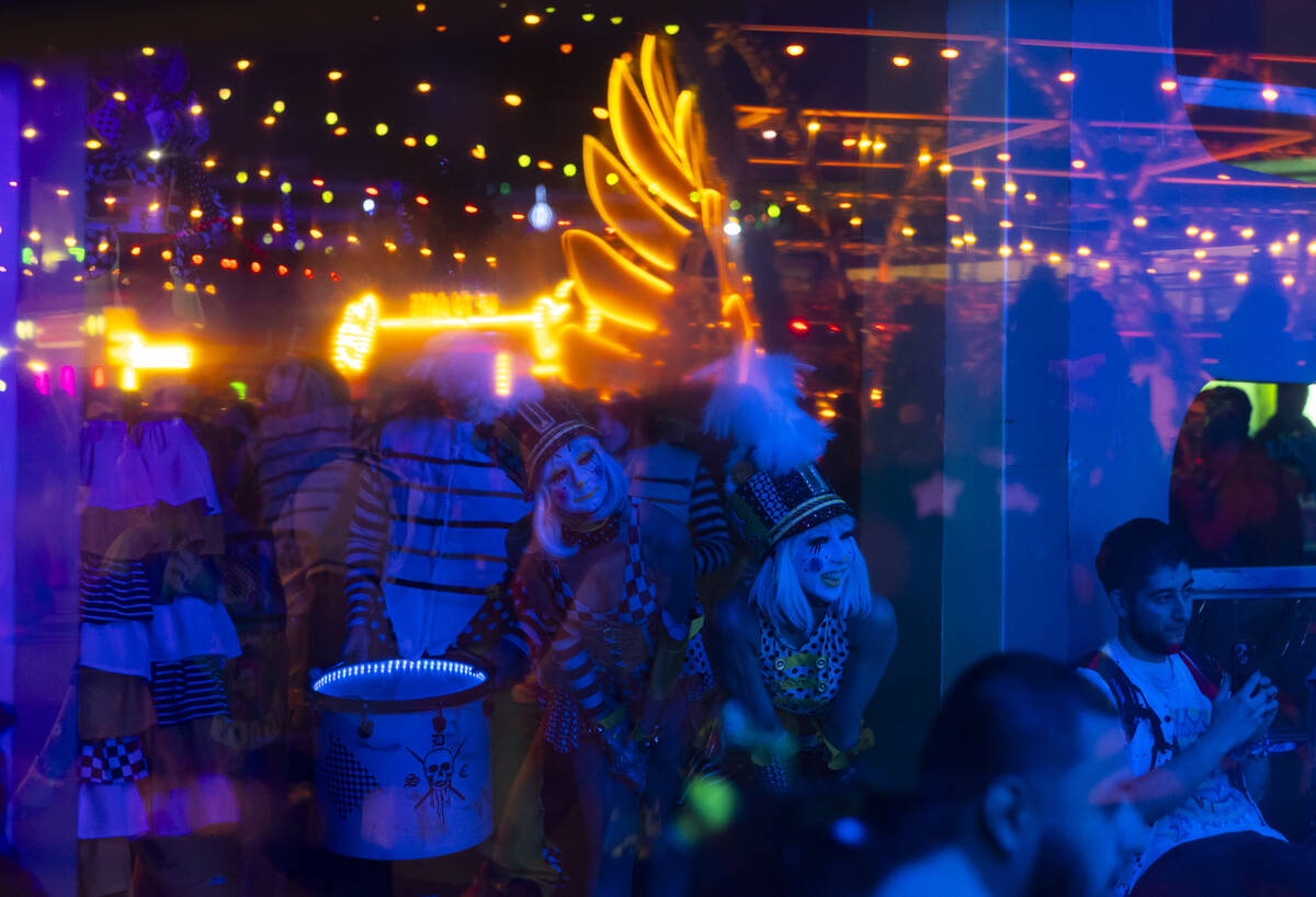 Clowns watch a wedding ceremony during the second night of the Electric Daisy Carnival at Las V ...