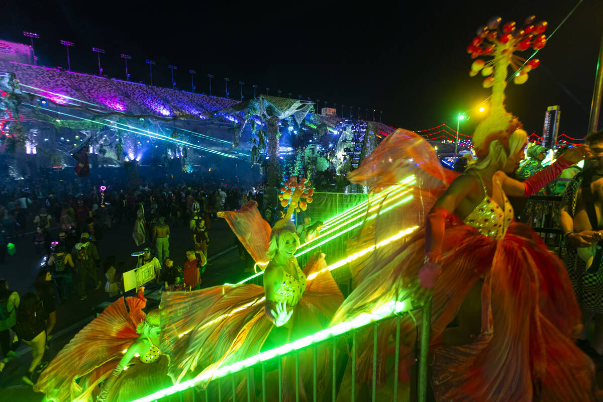 Costumed performs pass by during the second night of the Electric Daisy Carnival at Las Vegas M ...