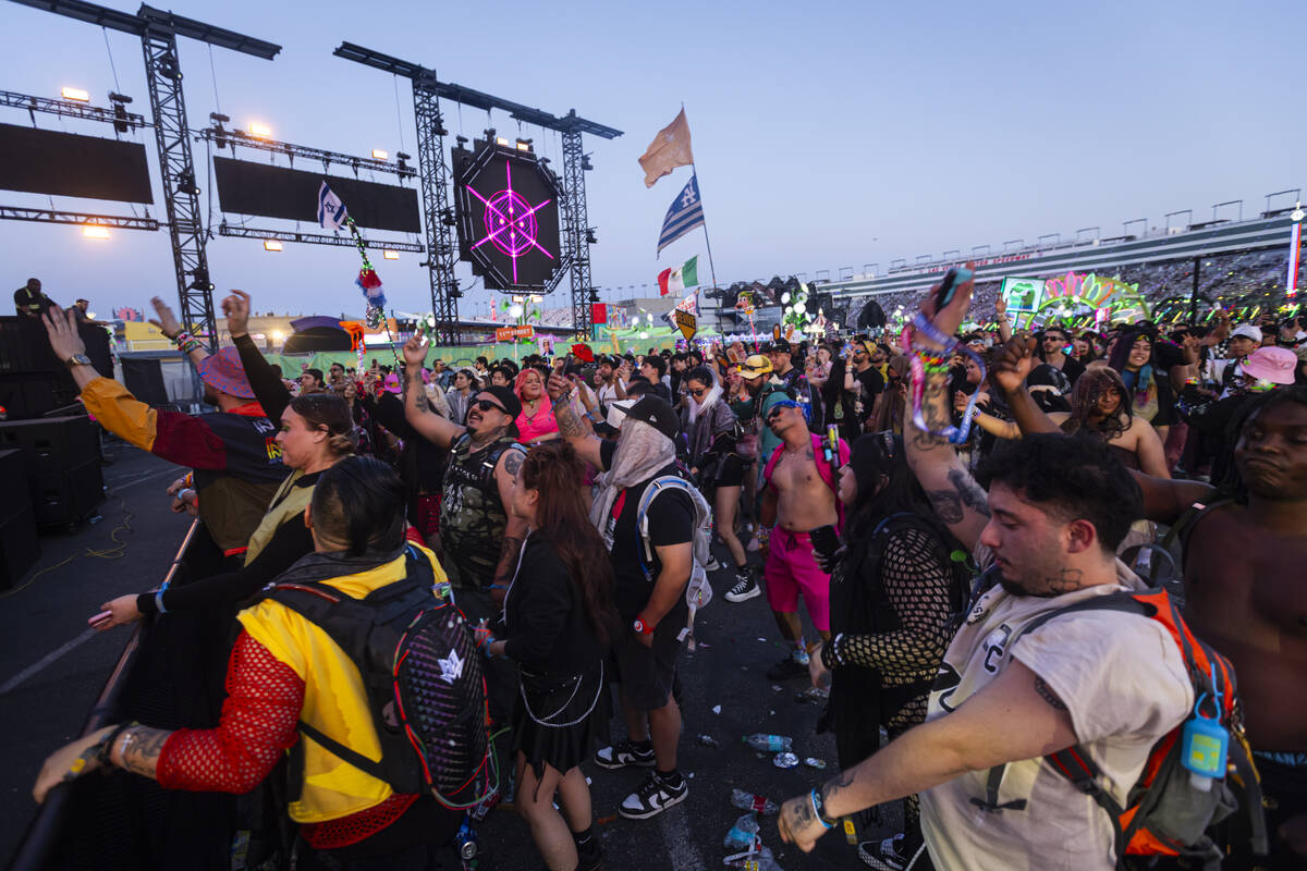 Attendees dance as the sun begins to rise following the final night of the Electric Daisy Carni ...