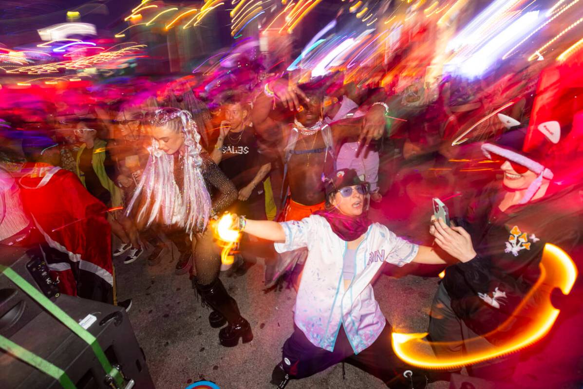 Attendees dance at the Ubuntu stage during the final night of the Electric Daisy Carnival at La ...