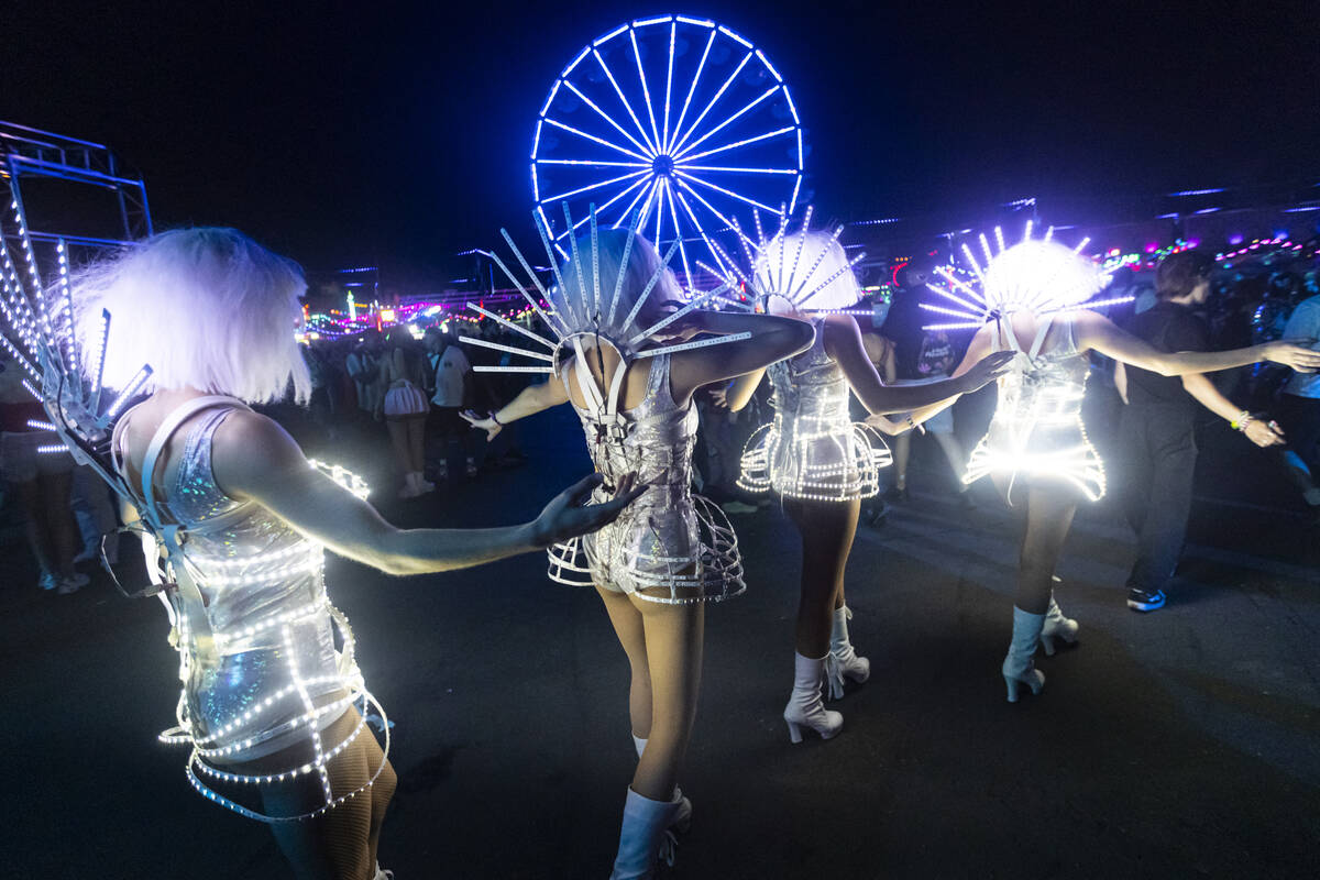 Costumed performers walk the festival grounds during the final night of the Electric Daisy Carn ...