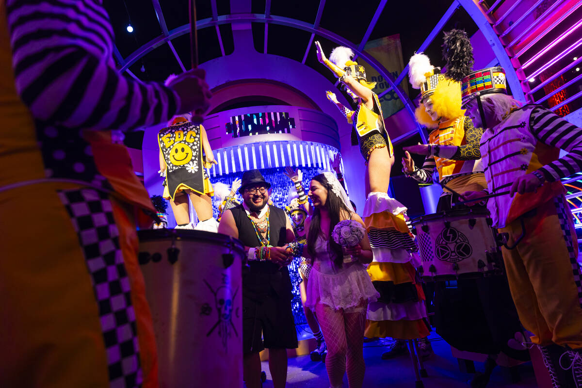 Newlyweds Miguel Sanchez, left, and Banely Legarda, of Las Cruces, N.M., walk down the aisle du ...