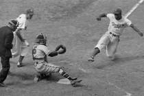 Brooklyn Dodgers star Jackie Robinson steals home as Boston Braves catcher Bill Salkeld is thro ...