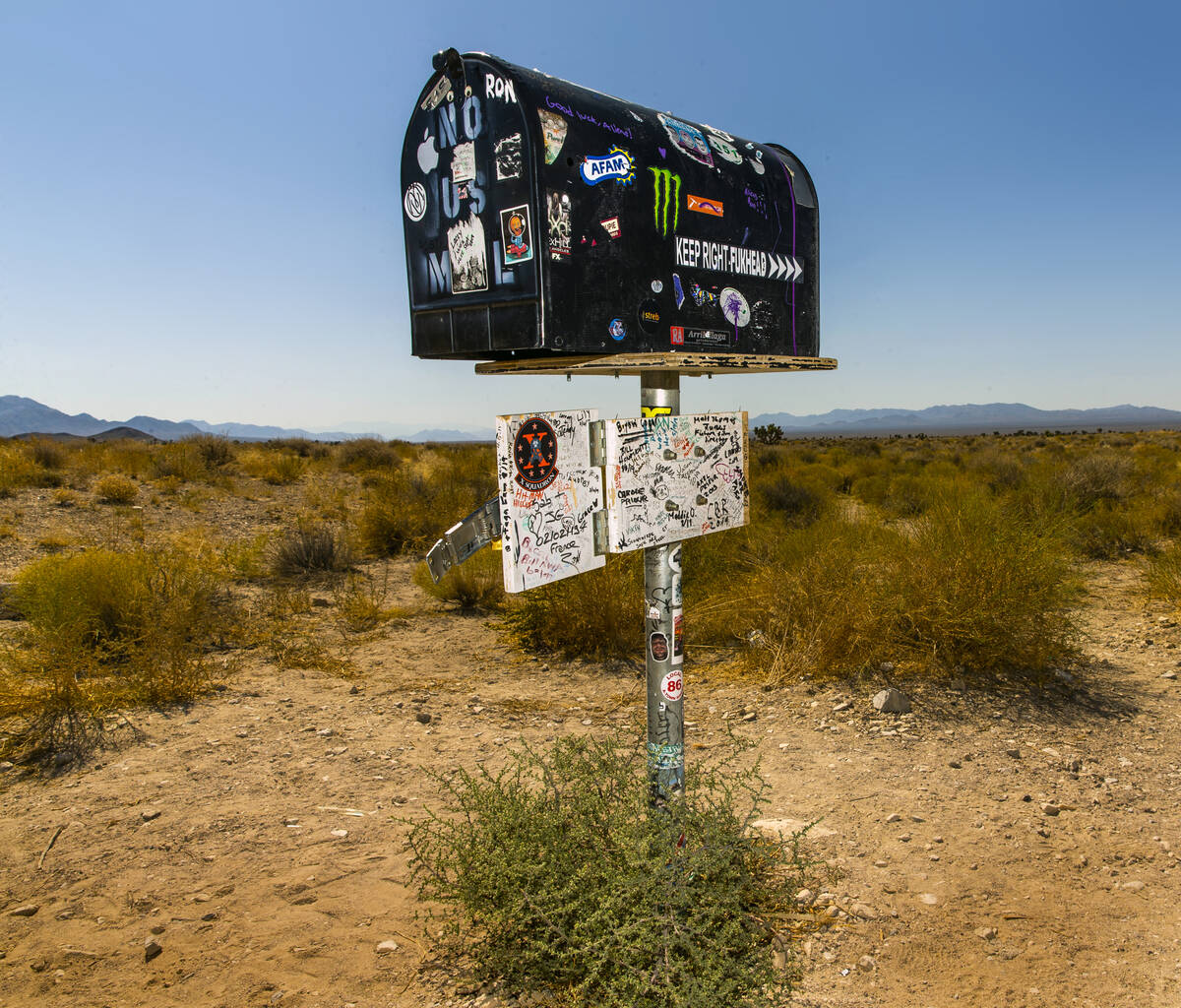 The famed Black Mailbox sits on the side of the road outside of Rachel and is still chock full ...