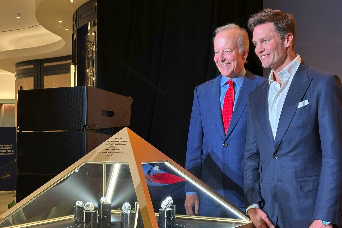 Jim Gray and Tom Brady are shown with Brady's seven Super Bowl rings at Fontainebleau's Urs Fis ...