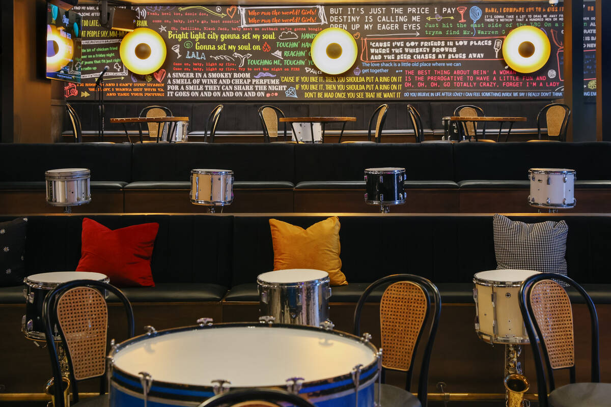 A mural with song lyrics decorates the back seating area of Smelly Cat, a new karaoke bar openi ...