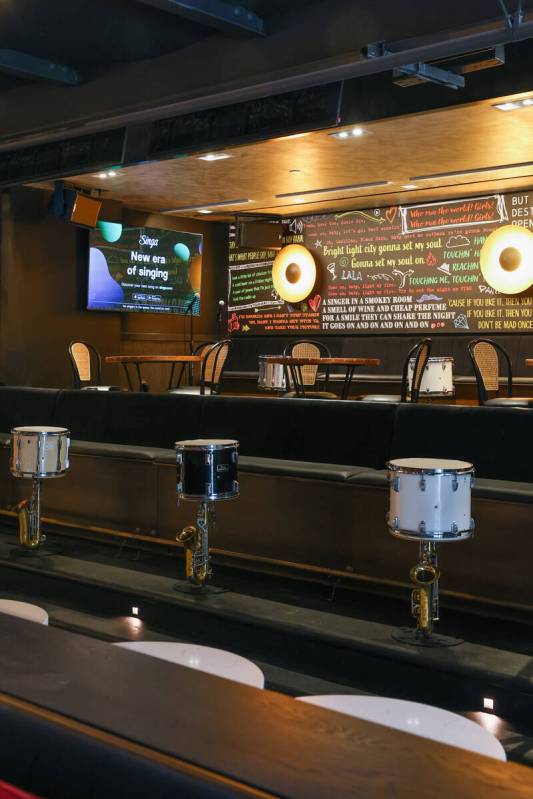 A mural with song lyrics decorates the back seating area of Smelly Cat, a new karaoke bar openi ...