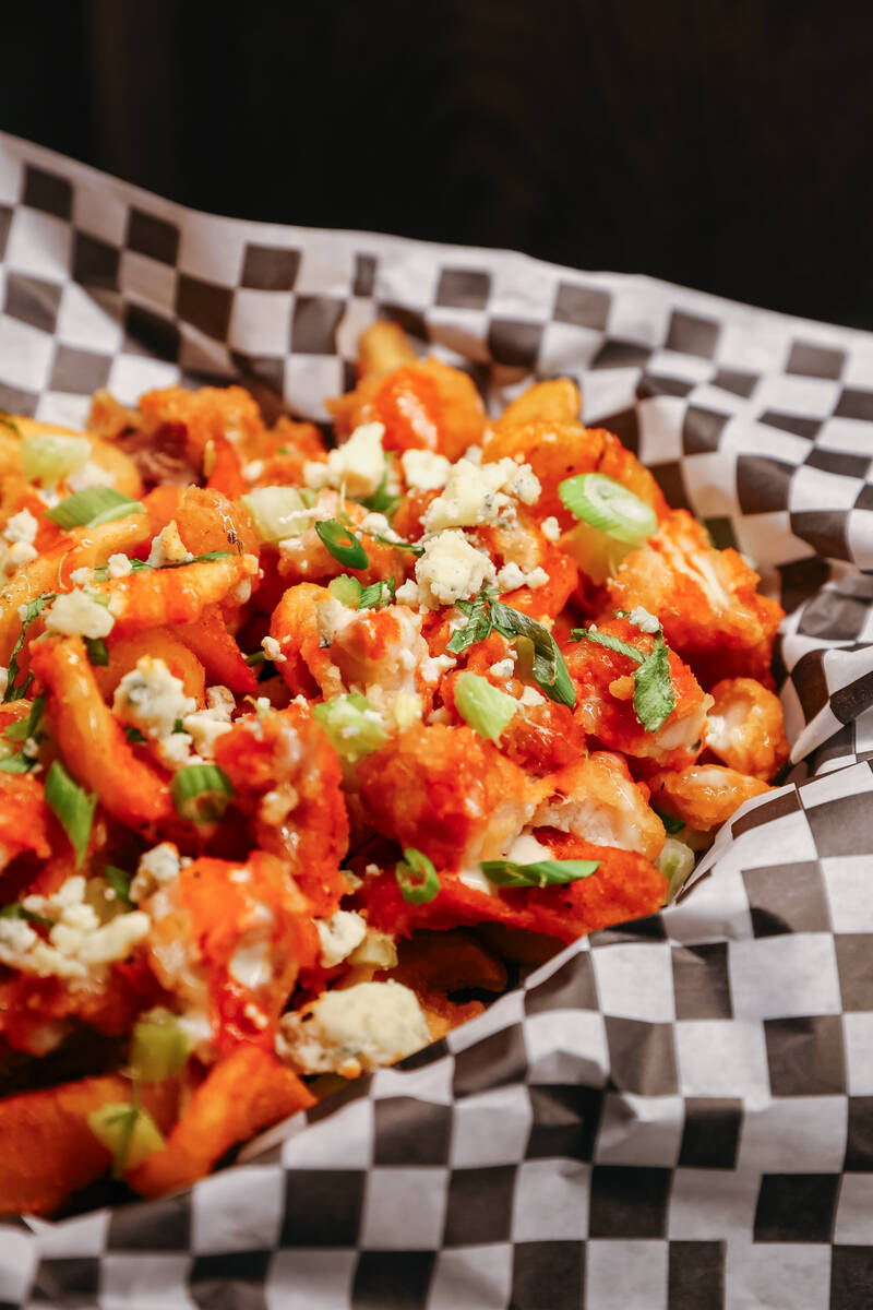 The buffalo chicken fries, with fried chicken, buffalo sauce, blue cheese crumbles, diced celer ...