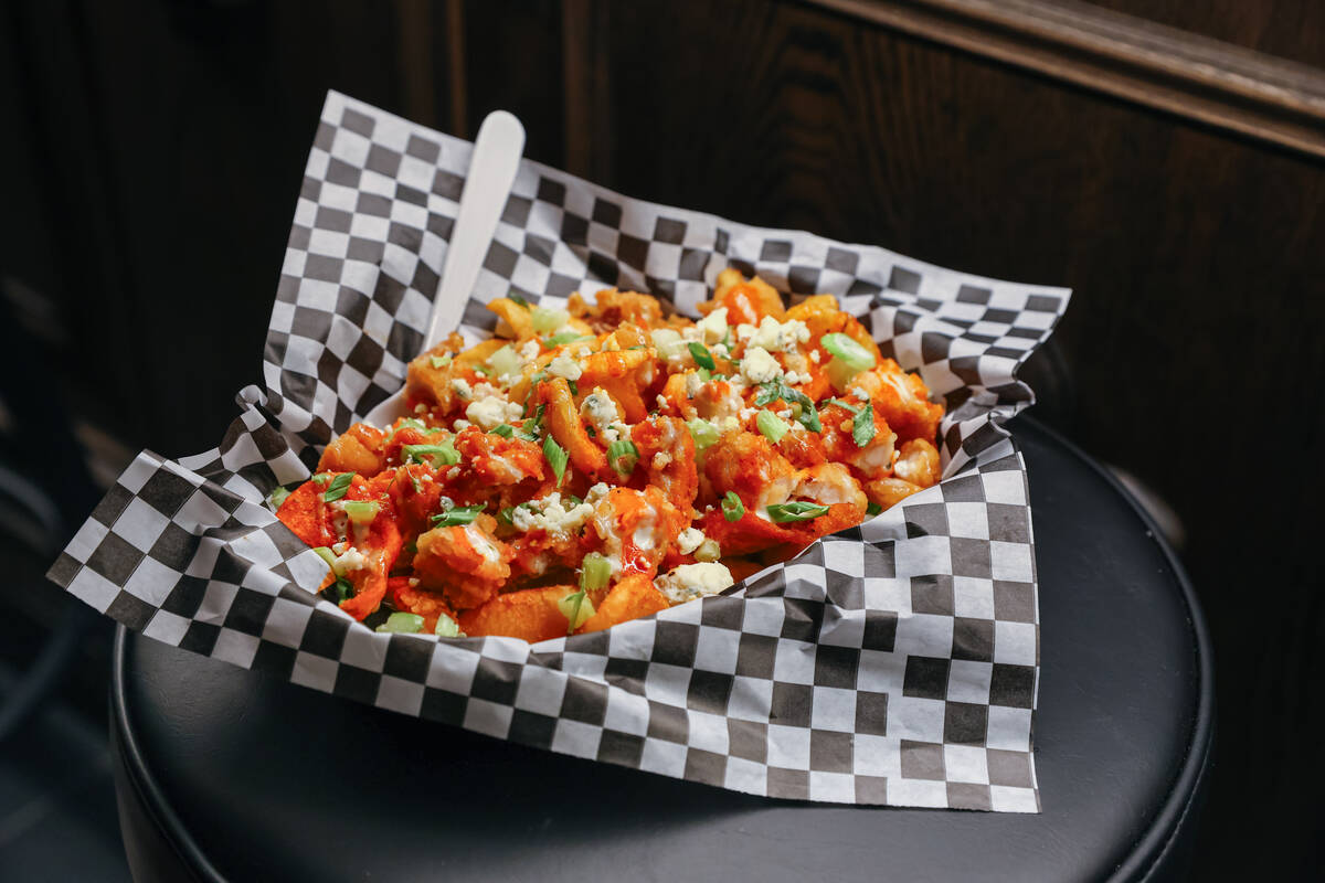 The buffalo chicken fries, with fried chicken, buffalo sauce, blue cheese crumbles, diced celer ...