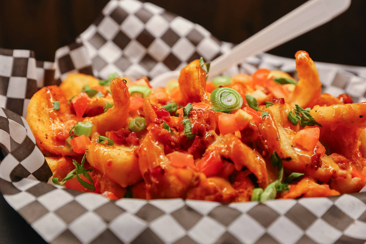 The bacon cheese fries, with queso, diced tomato, scallions, bacon and chipotle ranch, Smelly C ...
