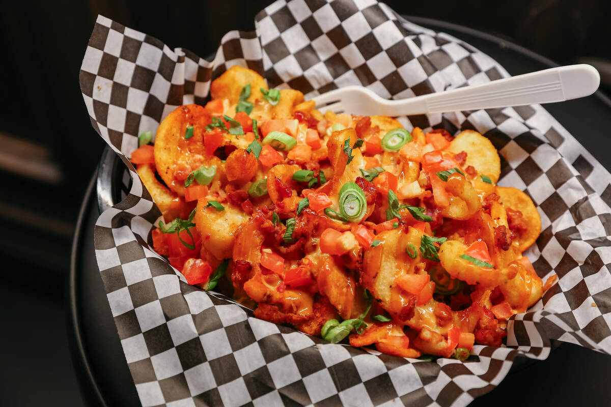 The bacon cheese fries, with queso, diced tomato, scallions, bacon and chipotle ranch, Smelly C ...