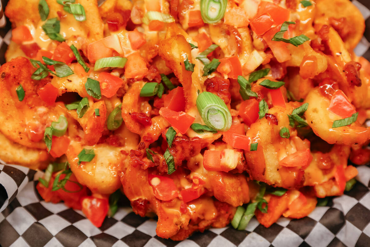 The bacon cheese fries, with queso, diced tomato, scallions, bacon and chipotle ranch, Smelly C ...