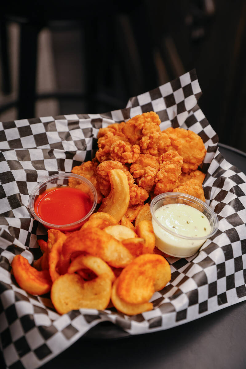 The popcorn chicken with dipping sauces, served with fries, at Smelly Cat, a new karaoke bar op ...
