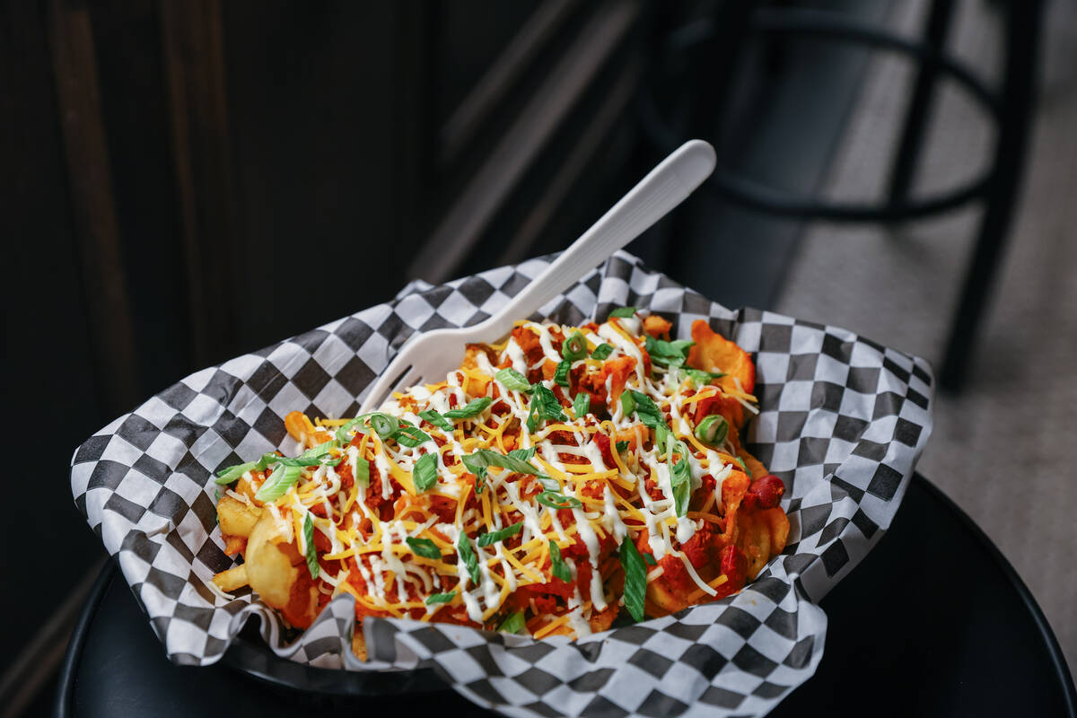 The chili cheese fries, with smoked brisket chili, shredded cheese, sour cream and scallions, a ...