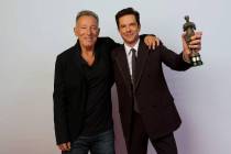 Bruce Springsteen is shown with Brandon Blowers after presenting the Killers' frontman with the ...