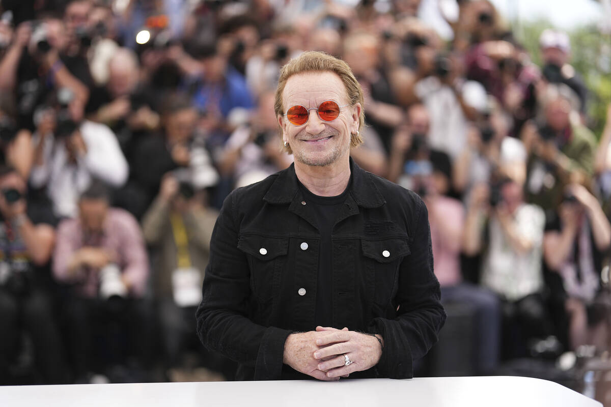 Bono poses for photographers at the photo call for the film 'Bono: Stories of Surrender' at the ...