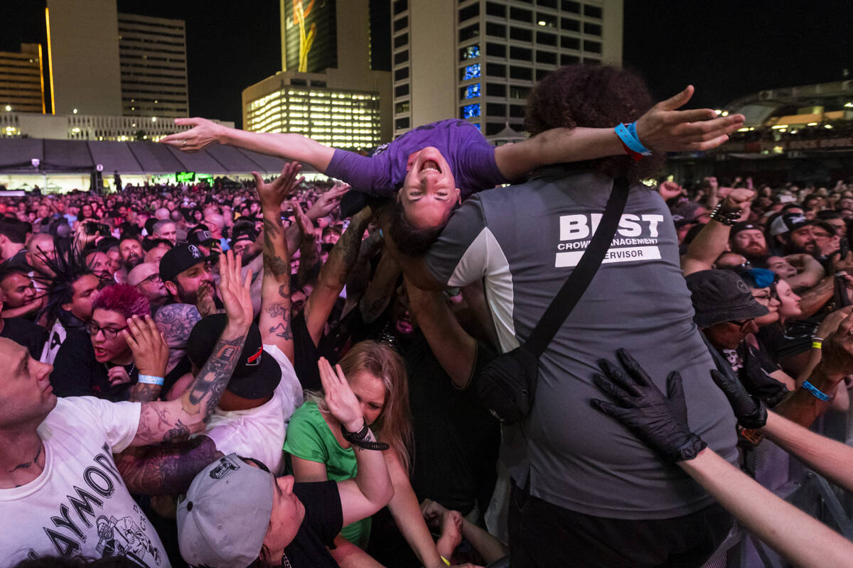 Attendees crowd surf as Cock Sparrer performs during the first day of the Punk Rock Bowling mus ...