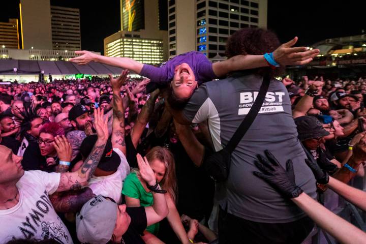 Attendees crowd surf as Cock Sparrer performs during the first day of the Punk Rock Bowling mus ...