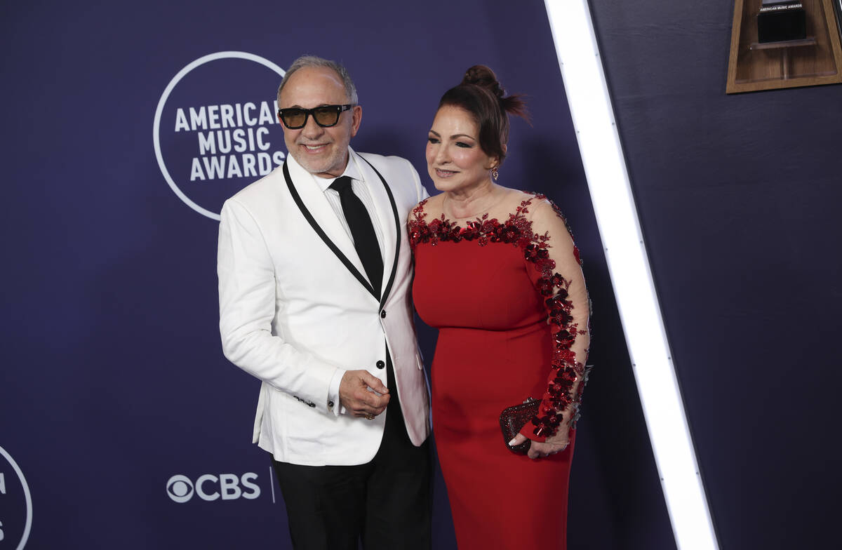 Emilio Estefan, left, and Gloria Estefan pose on the red carpet for the American Music Awards a ...