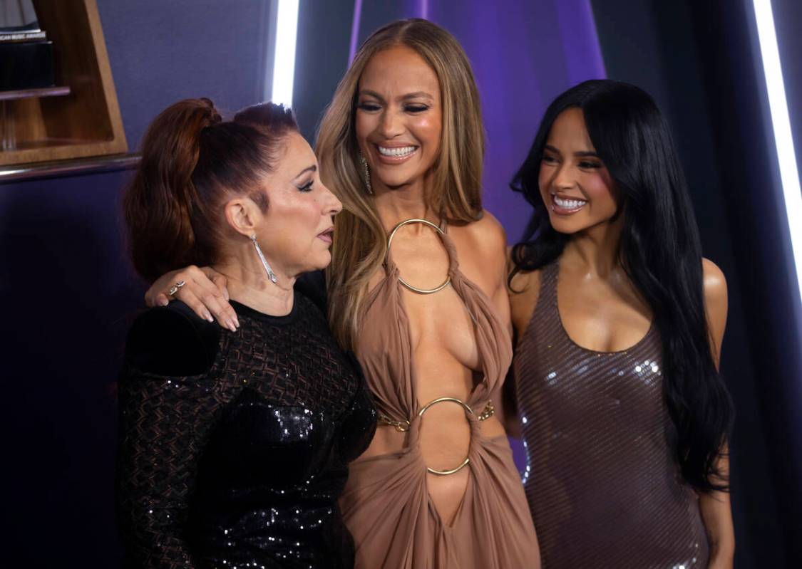 Jennifer Lopez, center, poses with Gloria Estefan and Becky G after the American Music Awards a ...