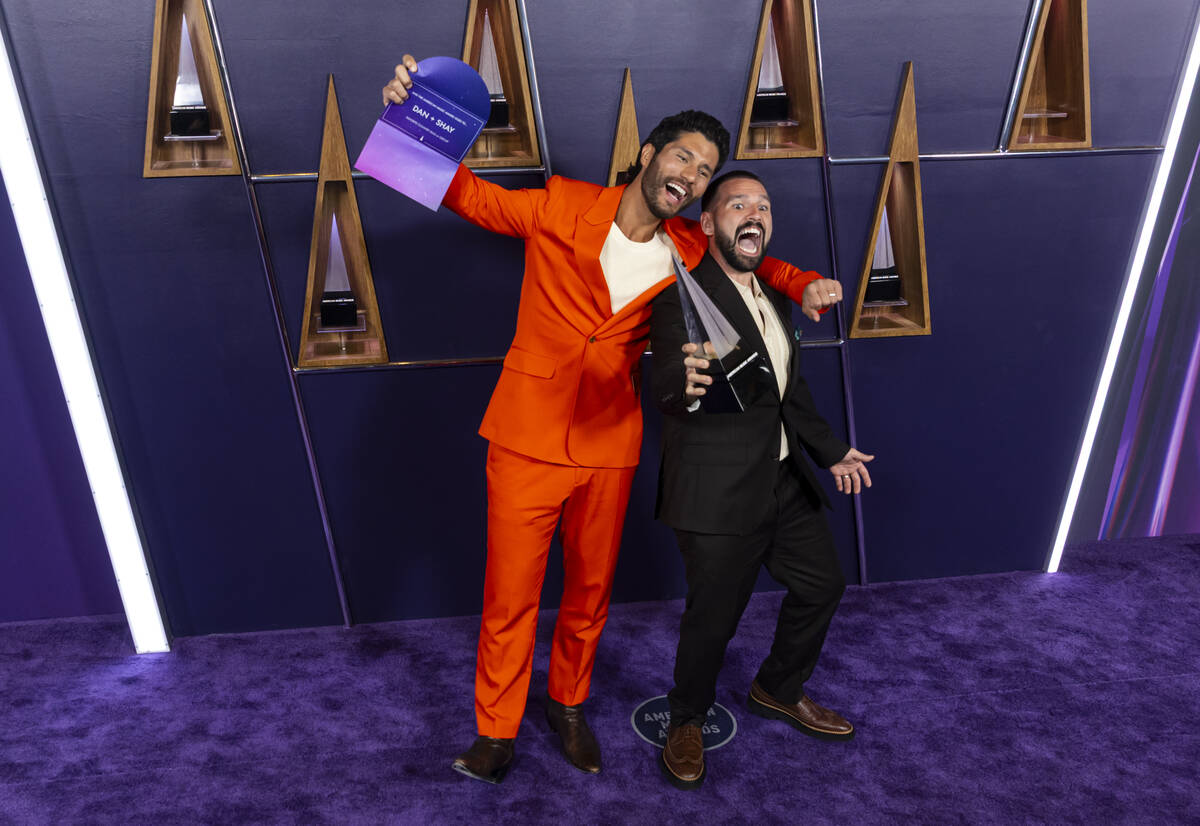 Dan + Shay pose with the Favorite Country Duo or Group award at the American Music Awards at Fo ...