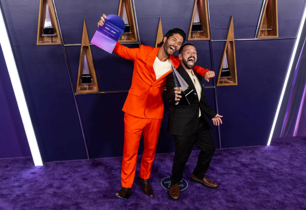 Dan + Shay pose with the Favorite Country Duo or Group award at the American Music Awards at Fo ...