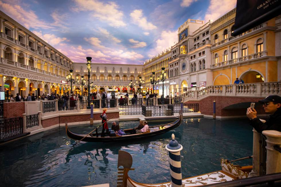 People take a gondola ride at the Grand Canal Shoppes at The Venetian in Las Vegas. (Chase Stev ...