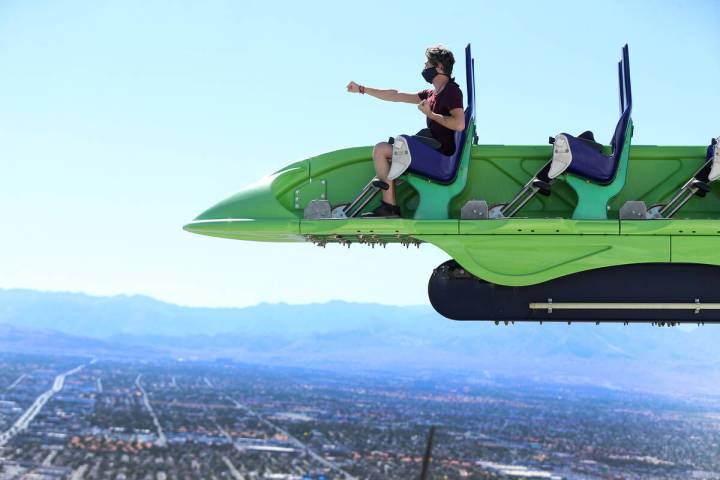 Jonathan Webster, 17, of Glenwood Springs, Colo., rides the X-Scream roller coaster at the Str ...