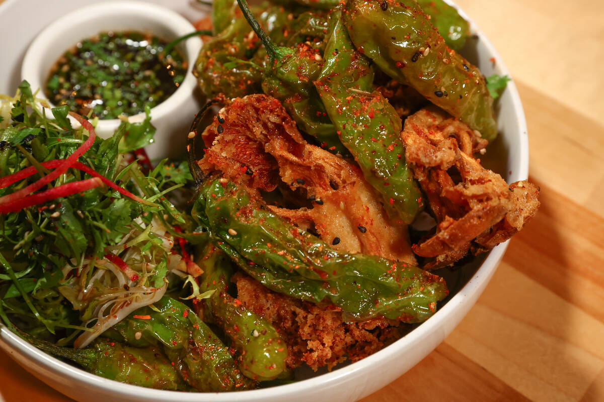 The crispy mushrooms, featuring lightly battered assorted mushrooms, shishito peppers, asian sl ...