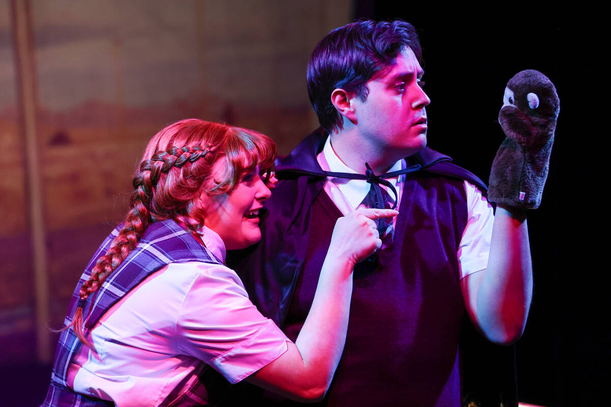 Emma Newton, playing Penny Lamb, and Jeffery DuBey, playing Ezra Lamb, interact with a monkey p ...