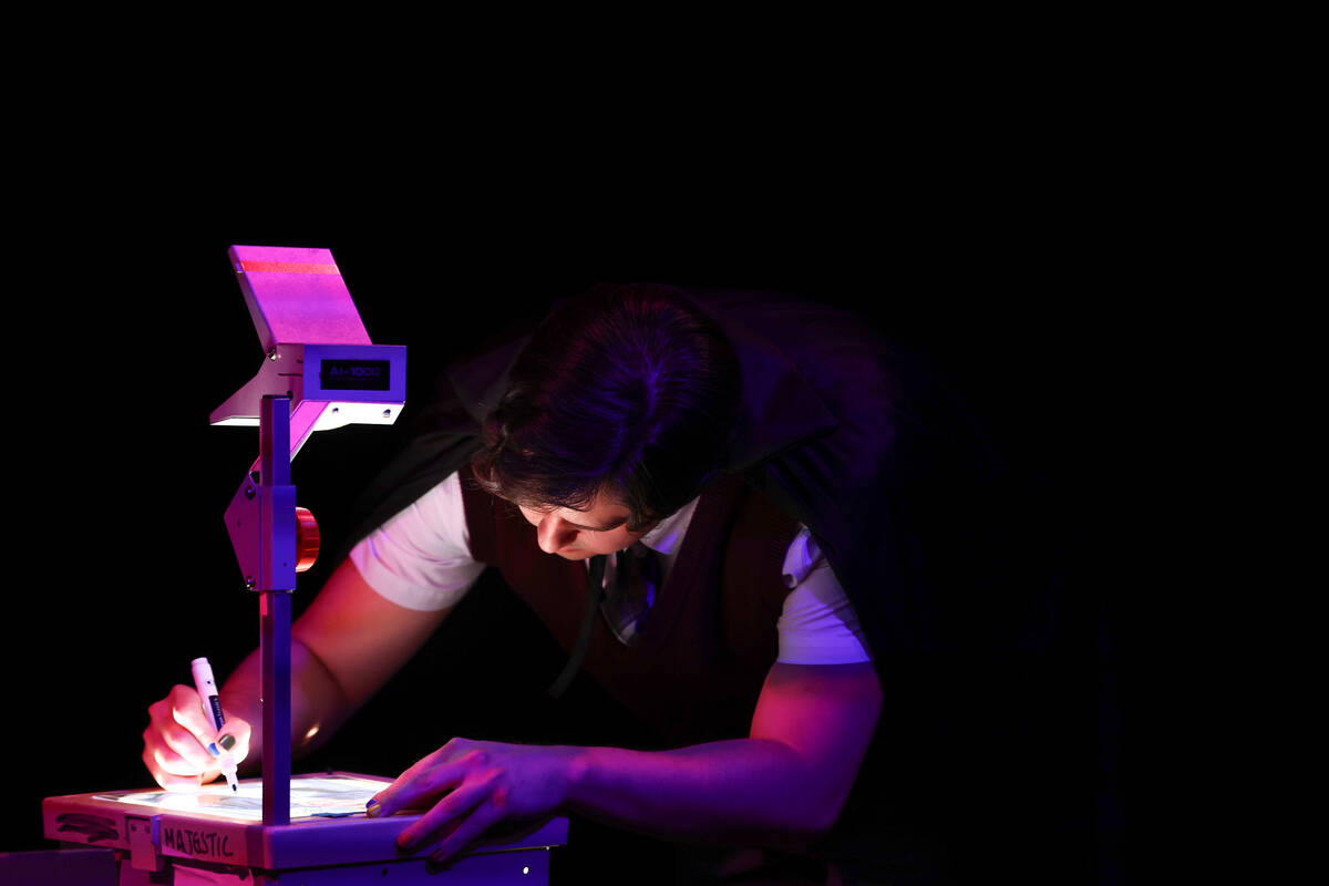 Jeffery DuBey, playing Ezra Lamb, draws on photo on the projector during Majestic Repertory The ...