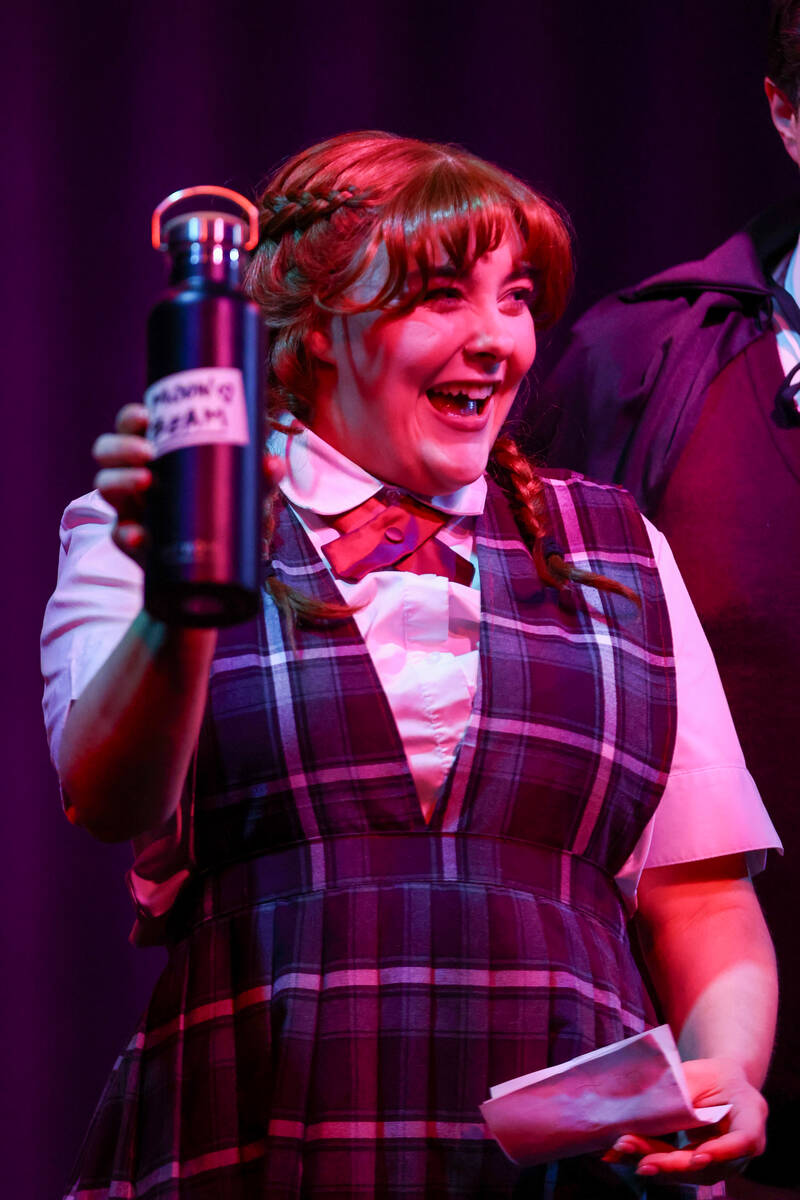 Emma Newton, playing Penny Lamb, holds up a thermos of “Moon Beam” during Majesti ...