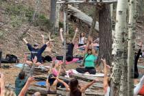 An outdoor yoga class is held in the quaking aspen grove of Lee Canyon on Sunday, June 8, 2025. ...