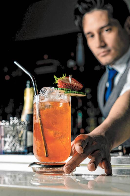 Luis "Lu" Lopez, bar director of Nocturno, presents a drink at the stylish cocktail bar that op ...