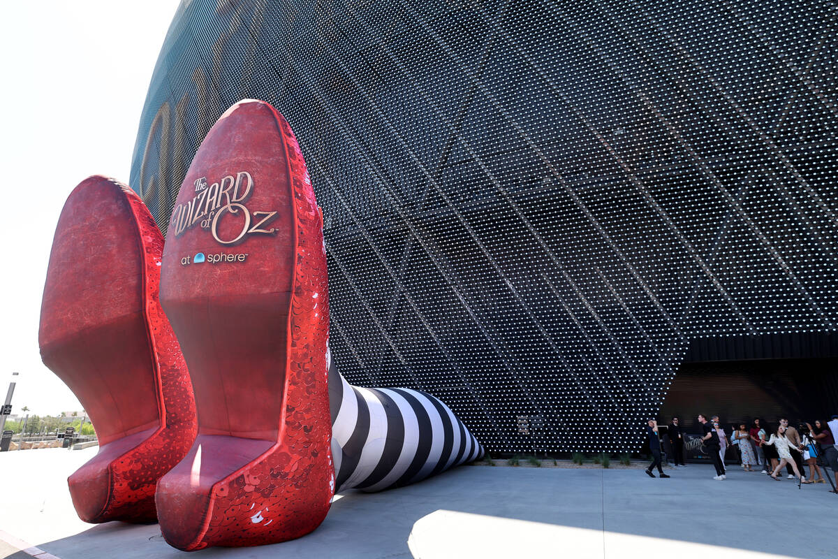 People check out The Wicked Witch of the East legs and ruby slippers installation promoting &qu ...