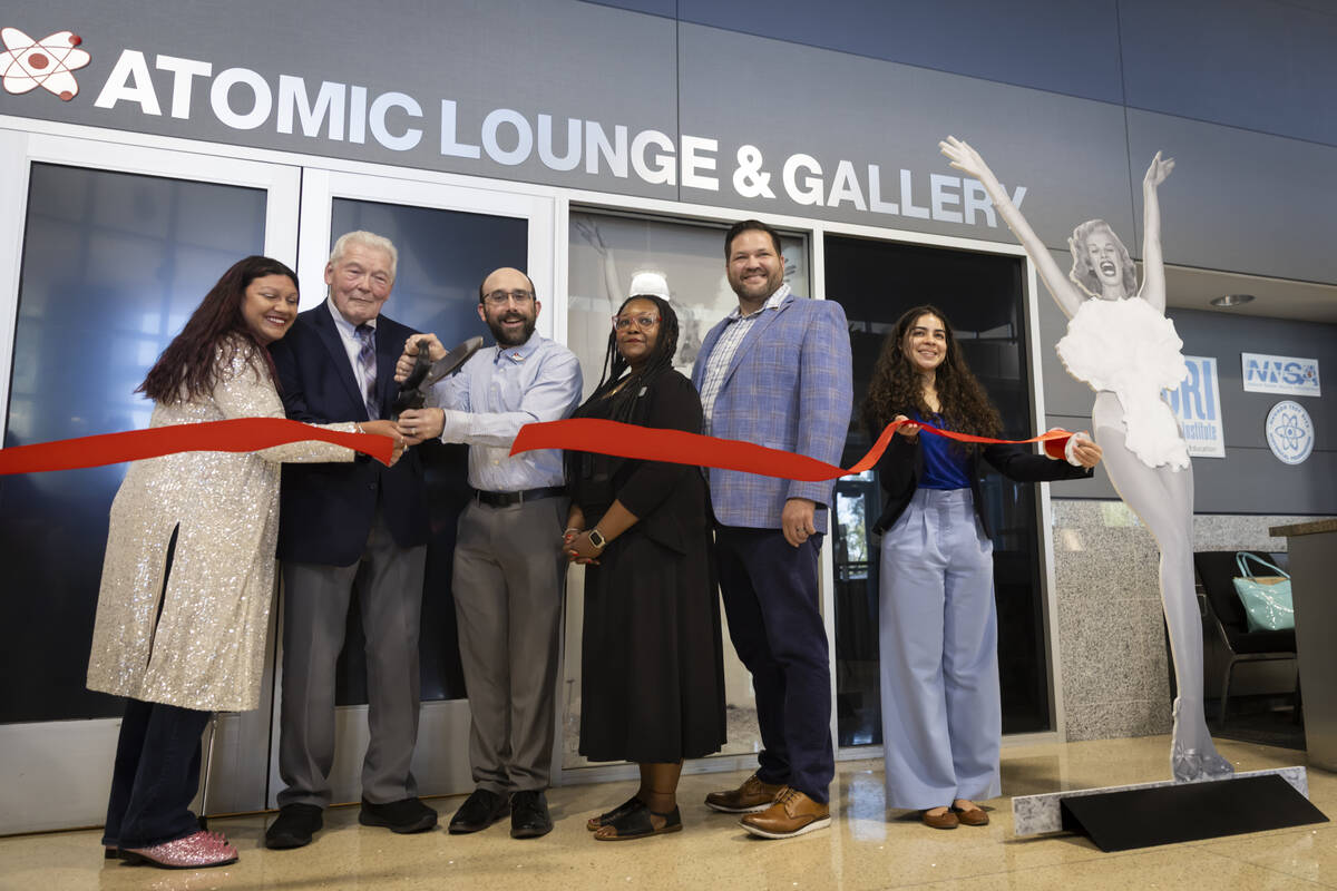 Officials participate in the ribbon-cutting ceremony for the “Miss Atomic Bomb: Icon of ...