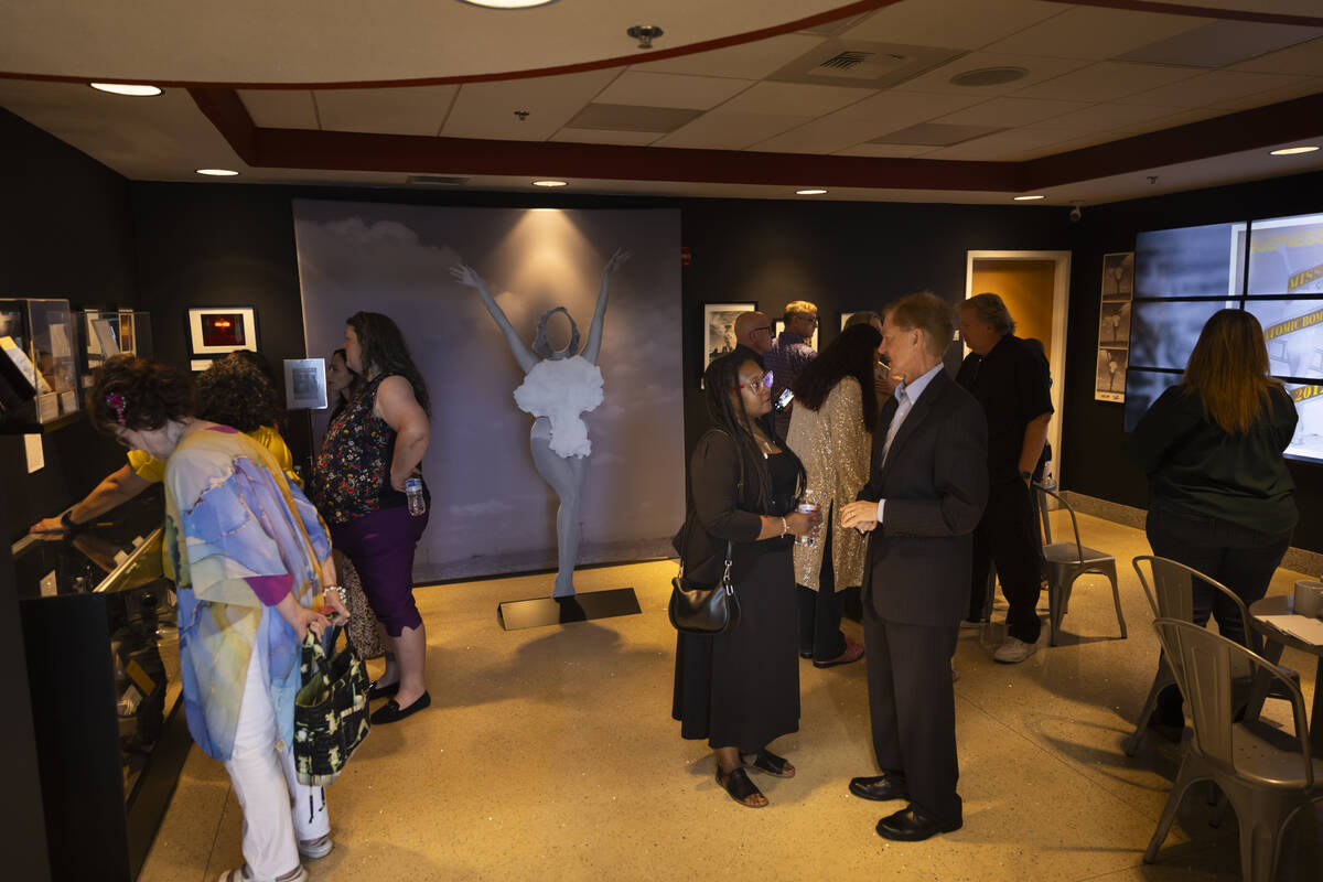 People explore the “Miss Atomic Bomb: Icon of the Atomic Age" exhibit at the Atomic ...