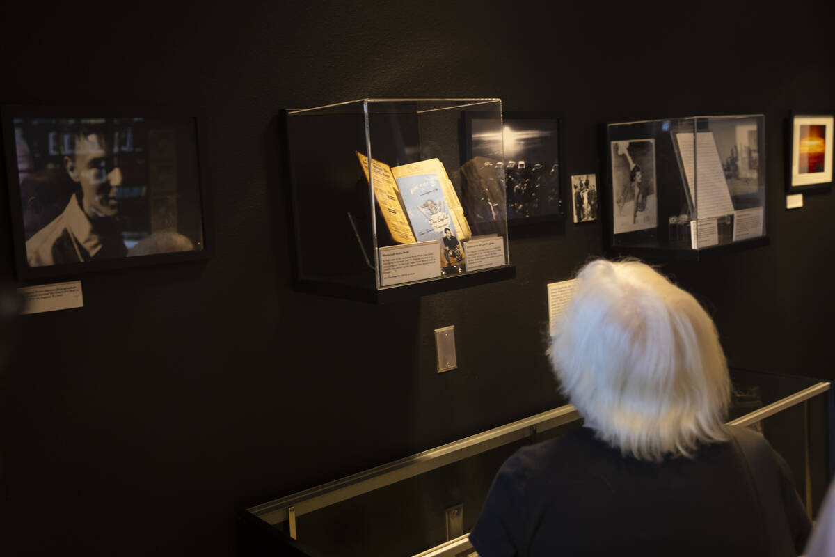 Attendees explore the “Miss Atomic Bomb: Icon of the Atomic Age" exhibit at the Ato ...