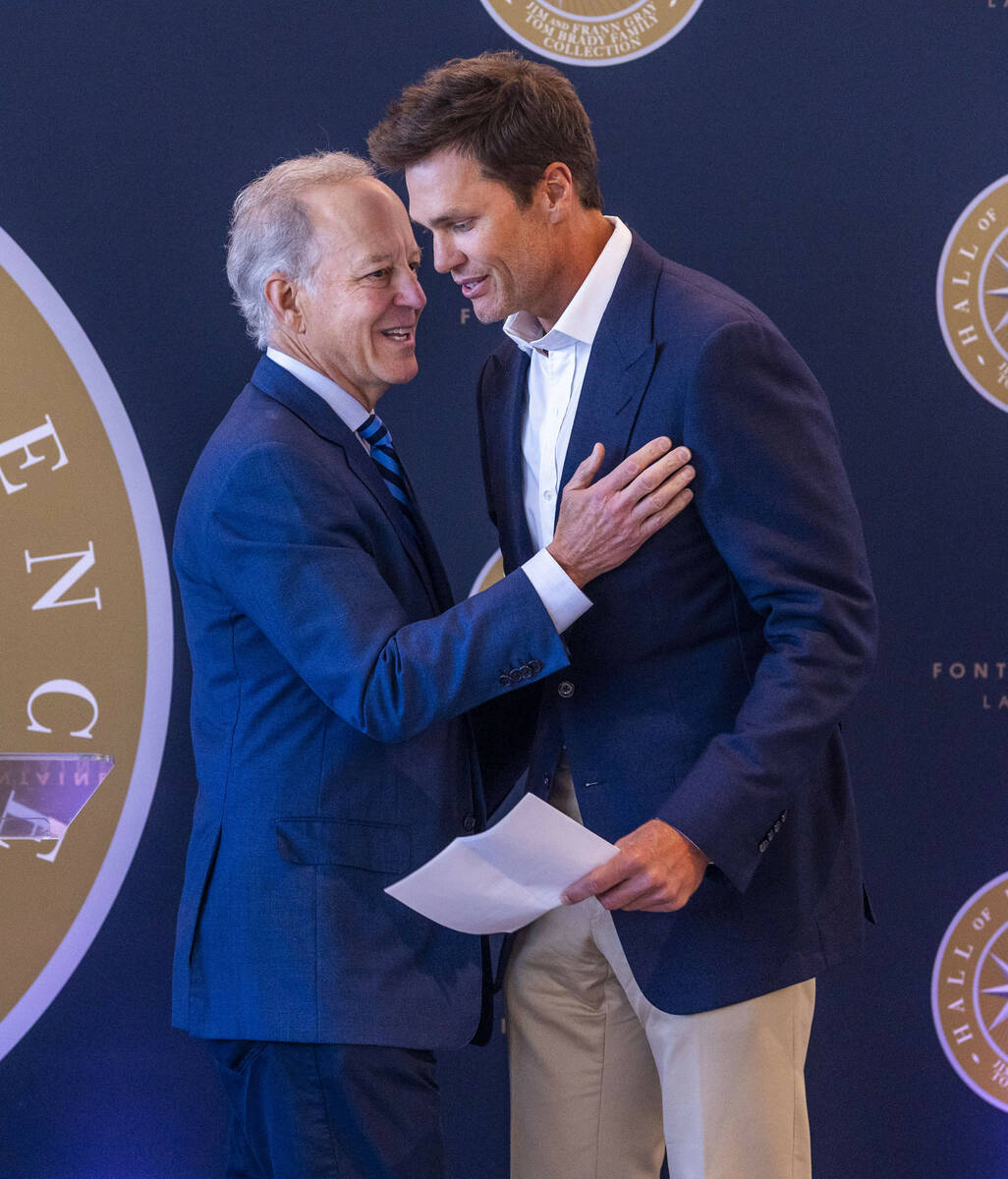 Jim Nance greets Tom Brady after introducing him to speak during the Hall of Excellence Press C ...