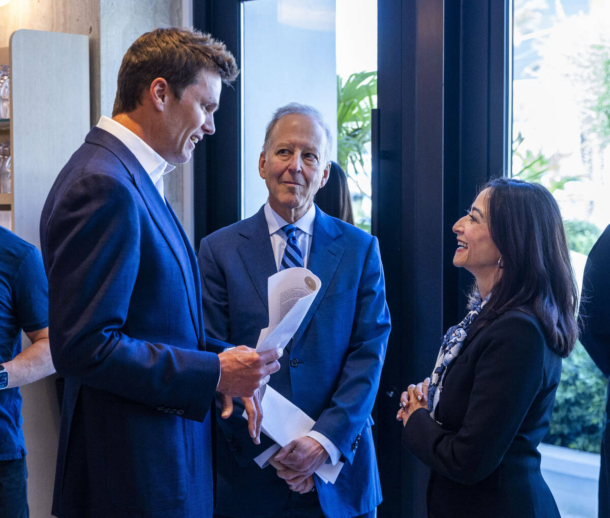 Tom Brady talks with Jim and Frann Nance arriving for the Hall of Excellence Press Conference a ...