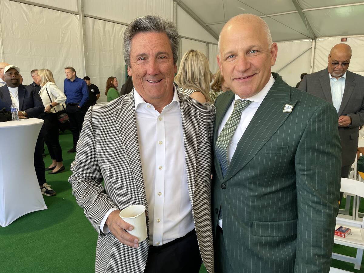 MGM Resorts International President and CEO Bill Hornbuckle is shown with Athletics President M ...