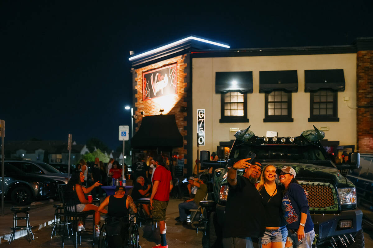 People hang out in the parking lot during the final night of operations for his bar, Count's Va ...